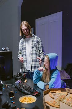 A young couple engaging in gaming with snacks and drinks in an indoor setting.