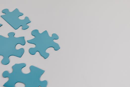 Close-up of blue puzzle pieces on a white background with copy space.