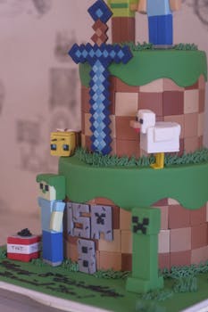 Colorful Minecraft themed cake featuring pixel art elements like sword and TNT block, perfect for parties.